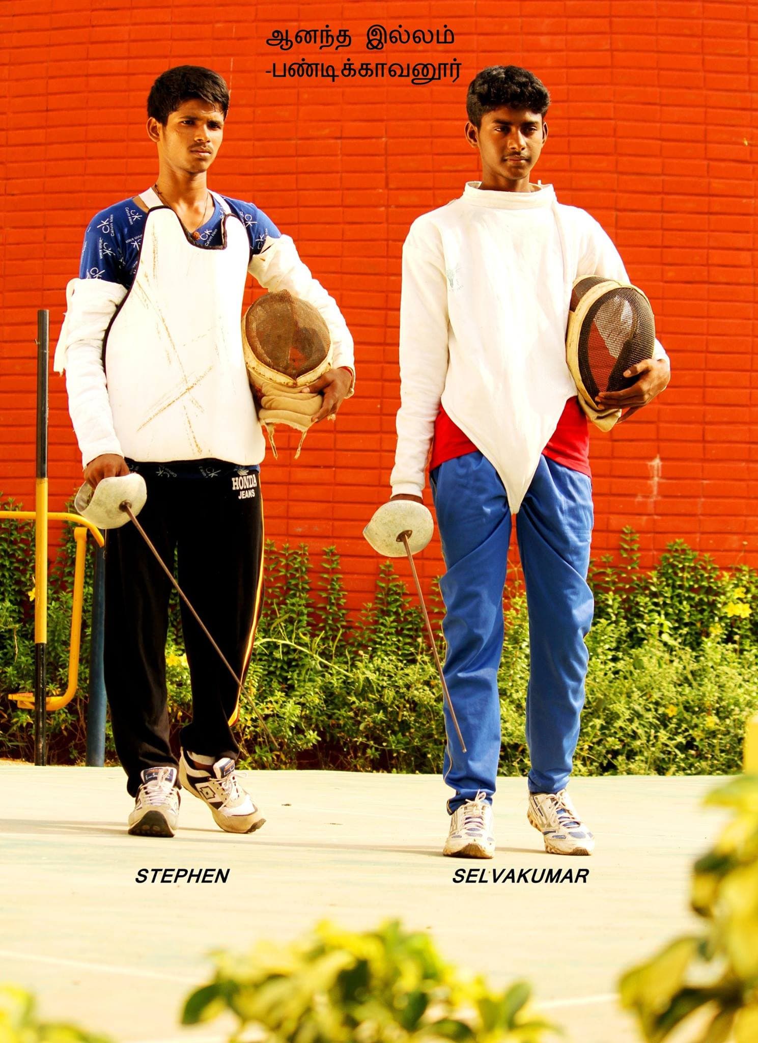 Two young CHES achievers standing proudly with fencing equipment