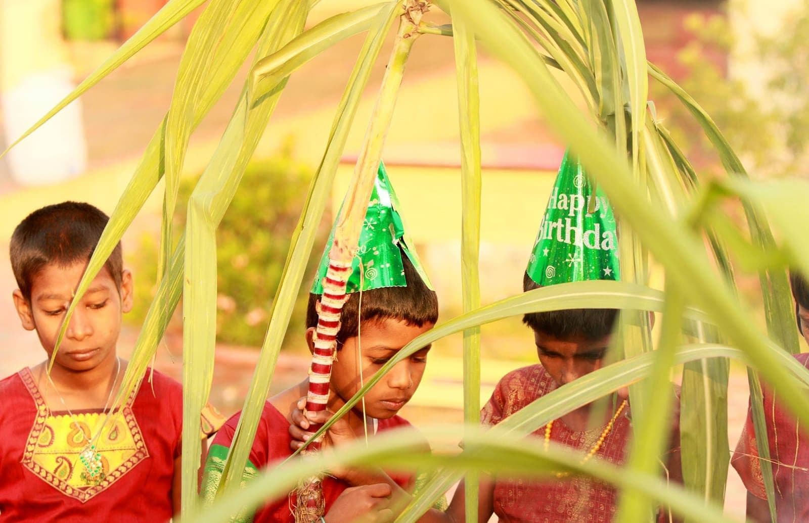 Children wearing party hats during a birthday celebration
