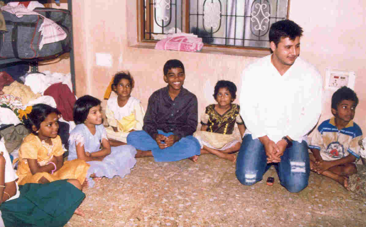 Children seated in a caring circle with a CHES volunteer