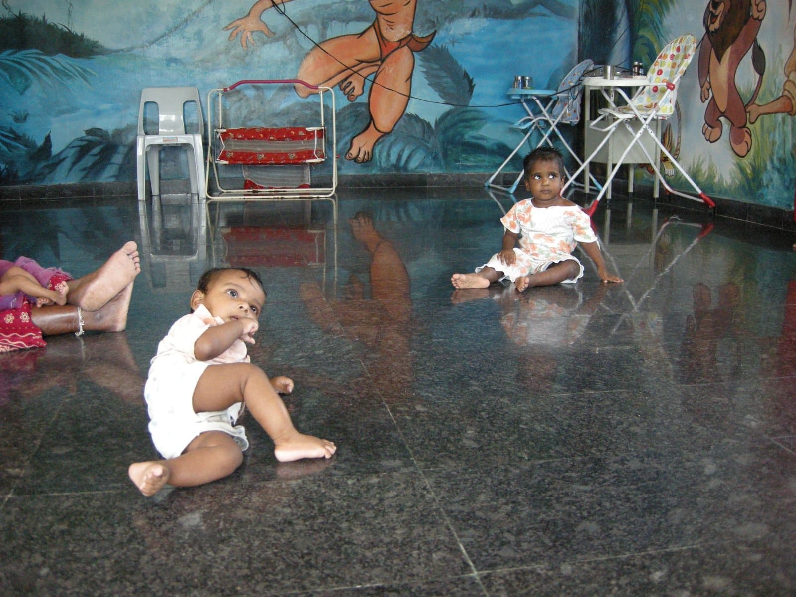 Young children playing together in a colourful CHES activity room
