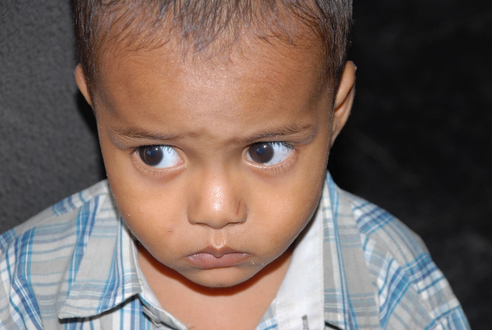 A young child in the care of CHES looking thoughtfully at the camera