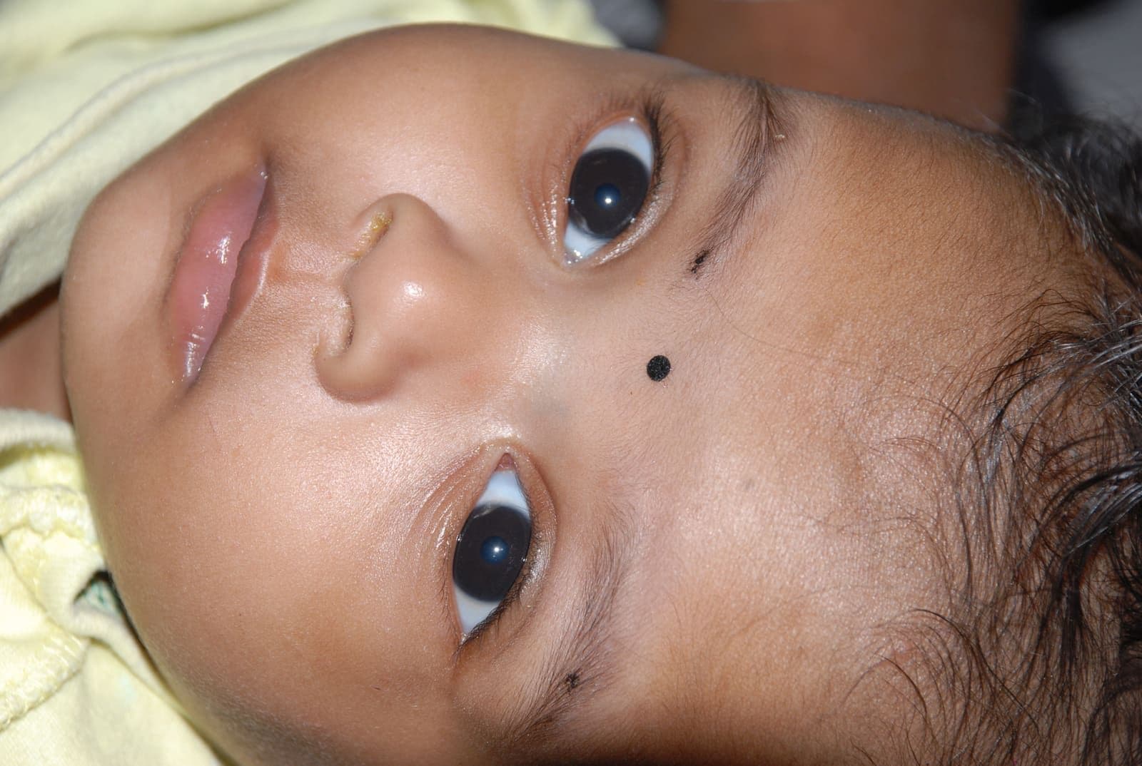 A baby resting safely during care at CHES