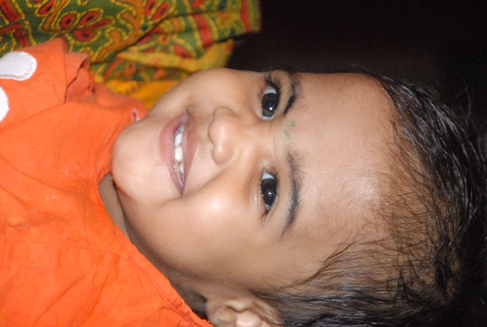 A smiling toddler receiving care through CHES