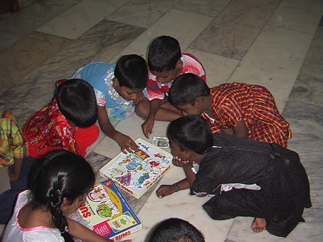 Children standing together in a CHES community care setting