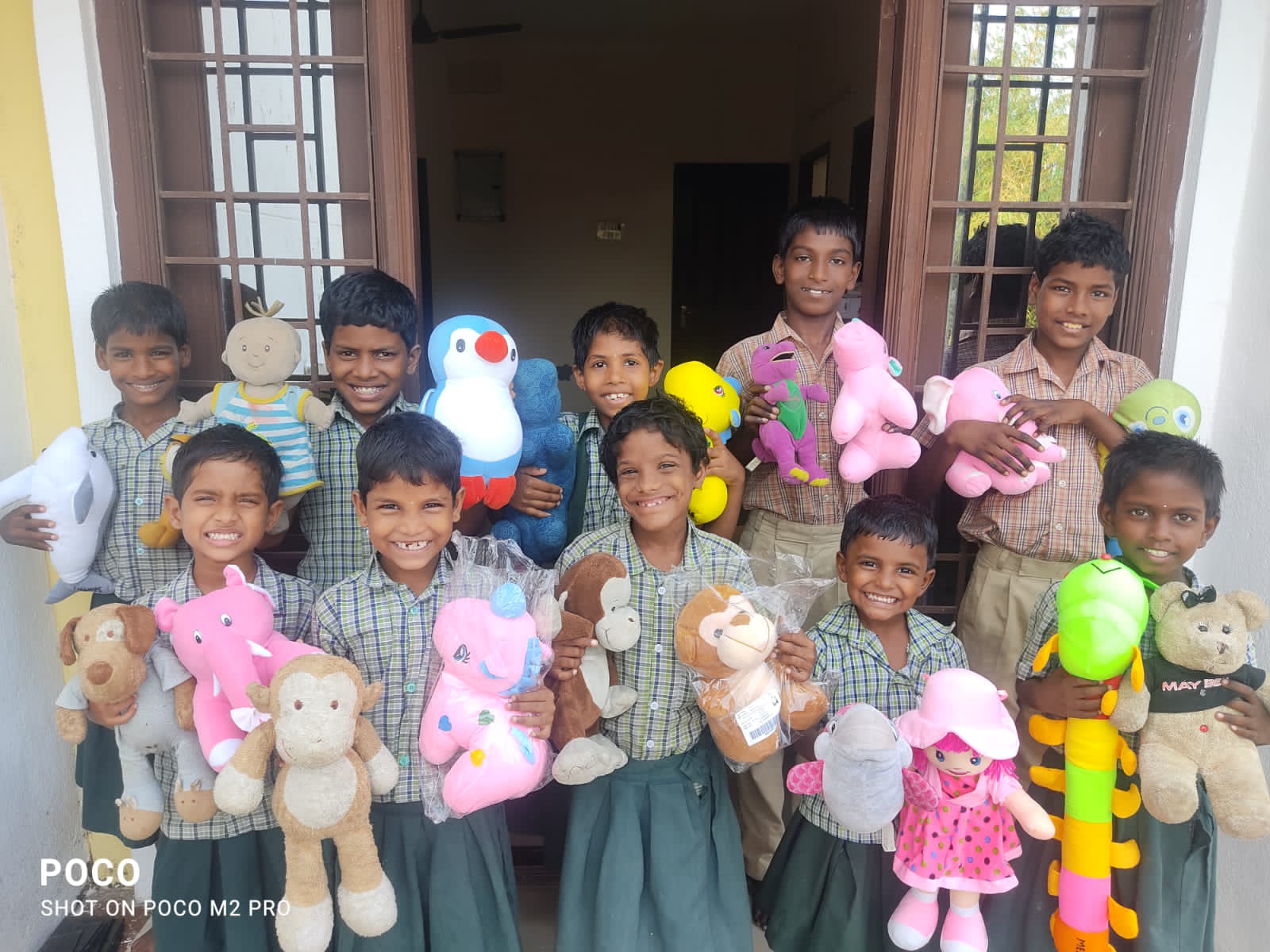 Children holding soft toys together at a CHES home